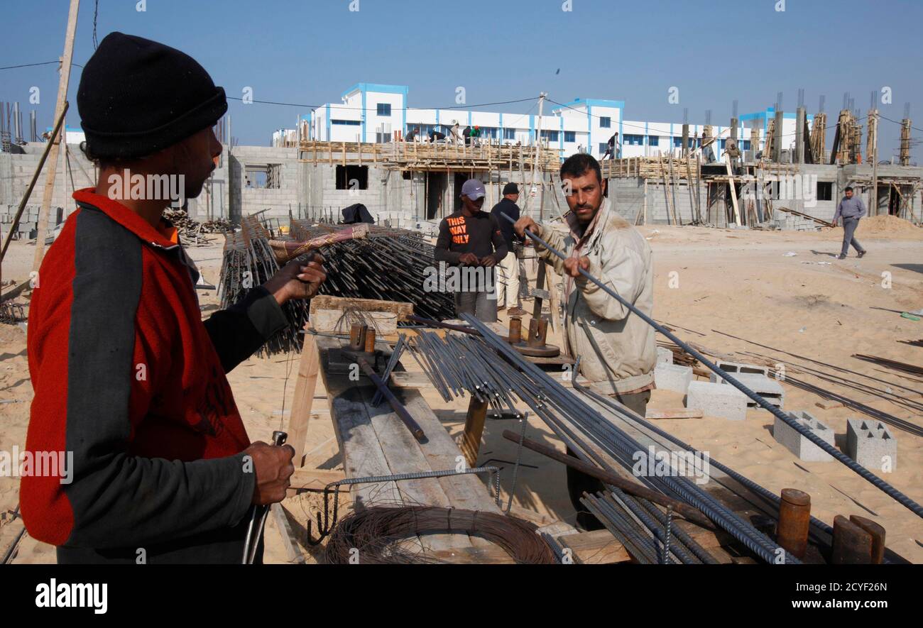 Palestinian labourers work at a construction site in Rafah in the southern Gaza Strip January 2, 2013. Israel eased its blockade of Gaza on Sunday, allowing a shipment of gravel for private construction into the Palestinian territory for the first time since Hamas seized control in 2007.  REUTERS/Ibraheem Abu Mustafa (GAZA - Tags: POLITICS BUSINESS CONSTRUCTION) Stock Photo