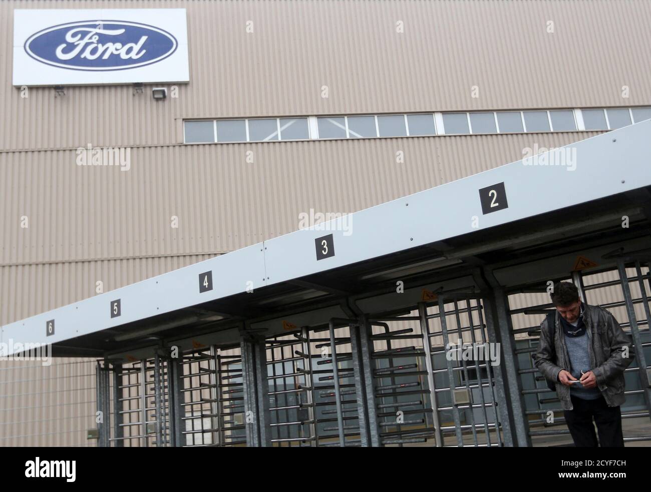 A worker leaves the factory for one of the final shifts at the Ford assembly plant in Genk December 17, 2014. In the heart of western Europe, the Belgian-Dutch-German rust belt has been dealt another blow. Two car plants closed this month as companies sought cheaper labour elsewhere, the final chapter of a manufacturing boom that began when coal mines fuelling Europe's industrialisation shut in the 1960s. Now the region straddling three borders is trying to reinvent itself. A 315 billion euro EU investment plan, announced on Thursday, is the latest potential help. It aims to encourage investor Stock Photo