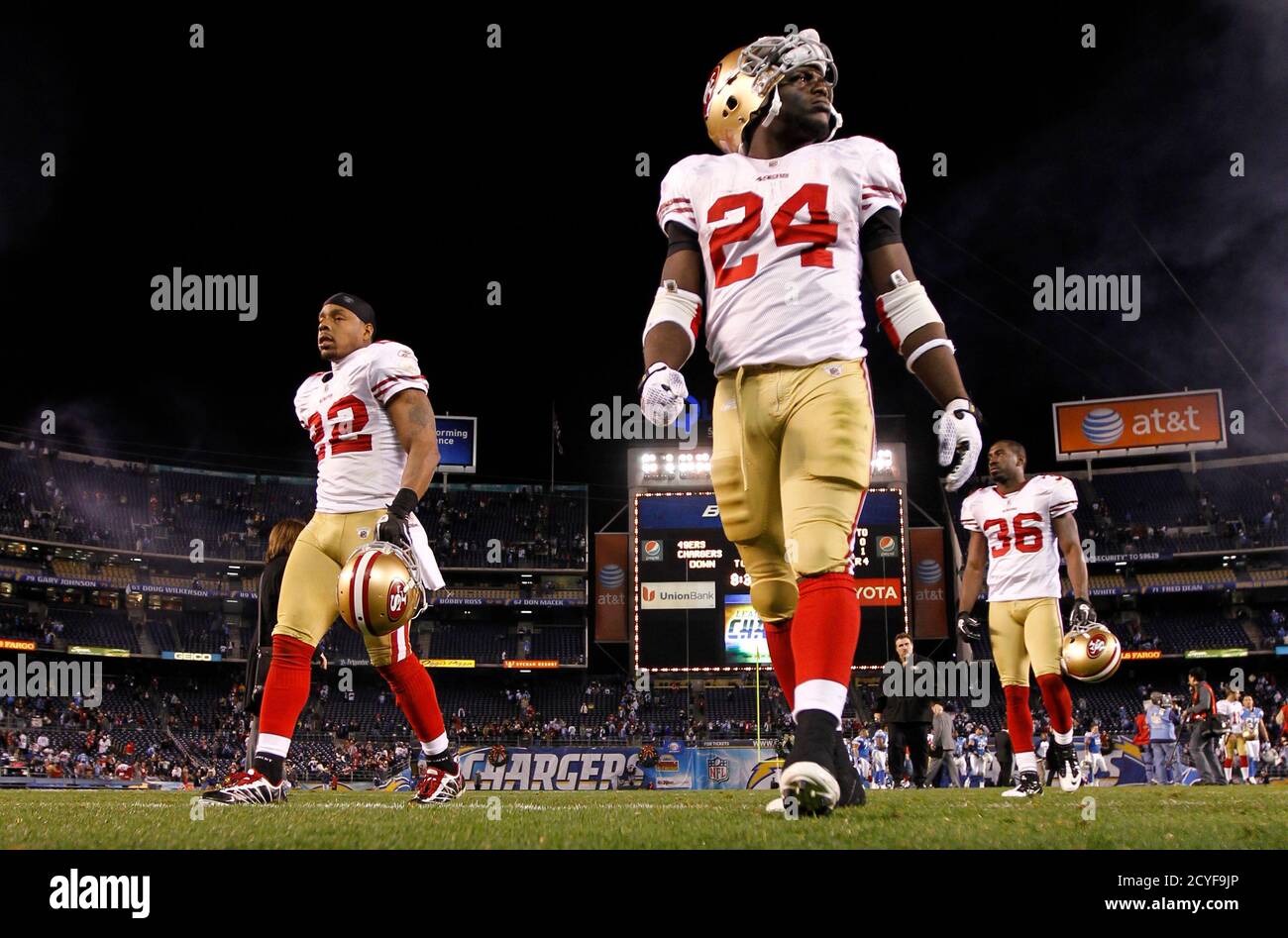 San Francisco 49ers running back Anthony Dixon (24) walks off the field with teammates Nate Clements (22) and cornerback Shawntae Spencer (36) after losing to the San Diego Chargers following their NFL football game in San Diego, California December 16, 2010. REUTERS/Mike Blake   (UNITED STATES - Tags: SPORT FOOTBALL) Stock Photo