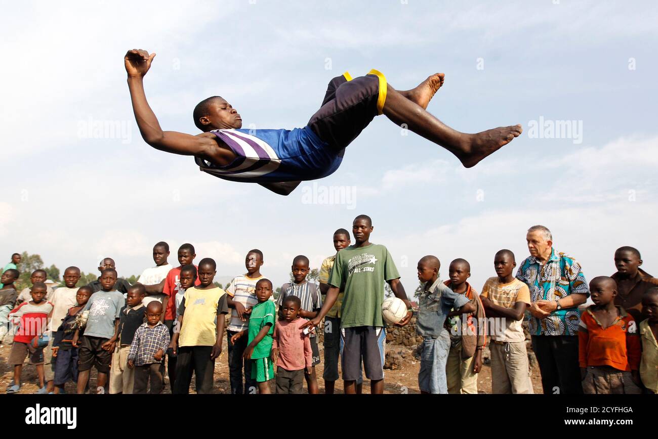 A youth jumps through the air as he plays at the Don Bosco Ngangi community center in Goma, North Kivu region, August 6, 2013. The center was established in 1988 and hosts over 3,000 abandoned children and HIV/AIDS victims. Recently they have been receiving victims from the fighting between the Congolese army known as the FARDC and the M23 rebels in North Kivu province, according to an official from the center.  REUTERS/Thomas Mukoya (DEMOCRATIC REPUBLIC CONGO - Tags: SOCIETY CIVIL UNREST HEALTH TPX IMAGES OF THE DAY) Stock Photo
