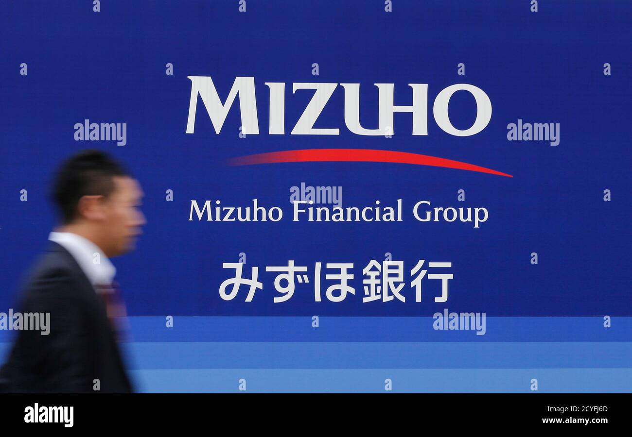A Man Walks Past A Branch Of Mizuho Financial Group S Mizuho Bank In Tokyo November 5 A Man Walks Past A Branch Of Mizuho Financial Group S Mizuho Bank In Tokyo November 5