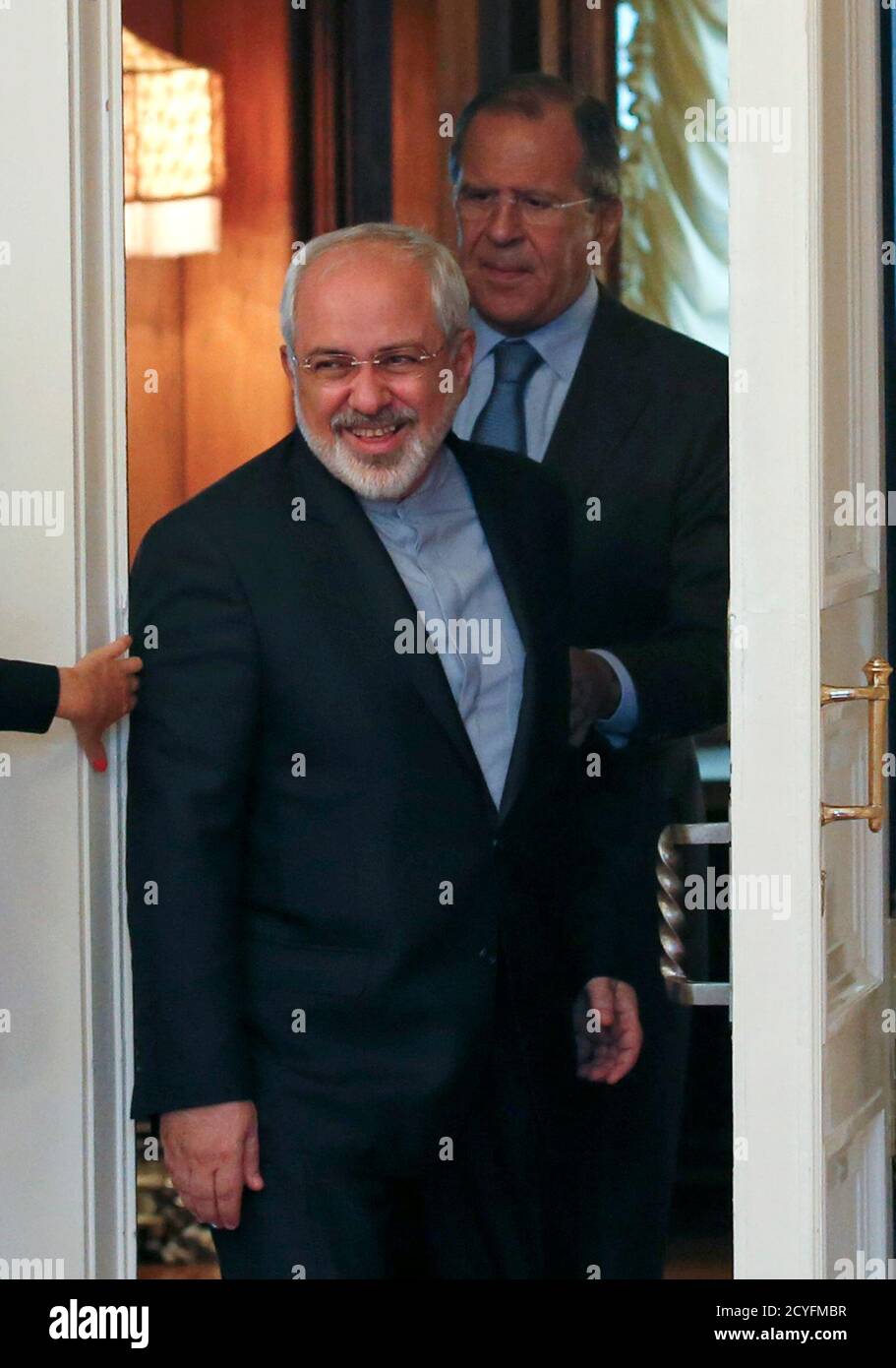 Iranian Foreign Minister Mohammad Javad Zarif (front) and his Russian counterpart Sergei Lavrov walk into a hall during a meeting in Moscow, August 29, 2014. Russia said on Thursday the possibility of lifting sanctions on Iran had emerged thanks to international talks on Tehran's nuclear program and urged all countries involved to show political will to reach a deal. Iranian Foreign Minister Mohammad Javad Zarif will meet his Russian counterpart Sergei Lavrov in Moscow on Friday to discuss the negotiations with six world powers on a decade-old stand-off over the Islamic Republic's nuclear ambi Stock Photo