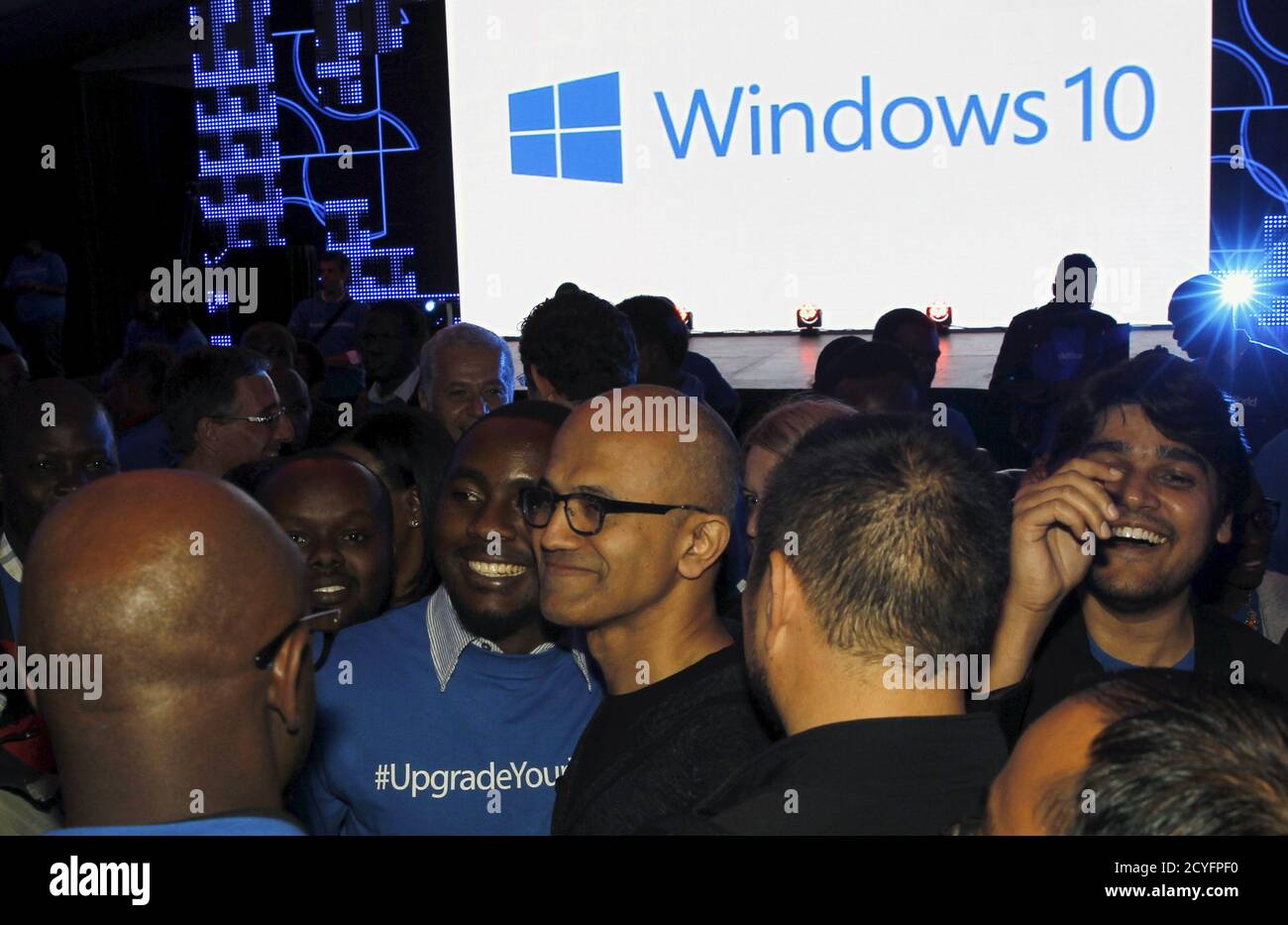 Microsoft CEO Satya Nadella (C) takes photographs with delegates after the launch of the Windows 10 operating system in Kenya's capital Nairobi, July 29, 2015. Microsoft Corp's launch of its first new operating system in almost three years, designed to work across laptops, desktop and smartphones, won mostly positive reviews for its user-friendly and feature-packed interface. REUTERS/Thomas Mukoya Stock Photo