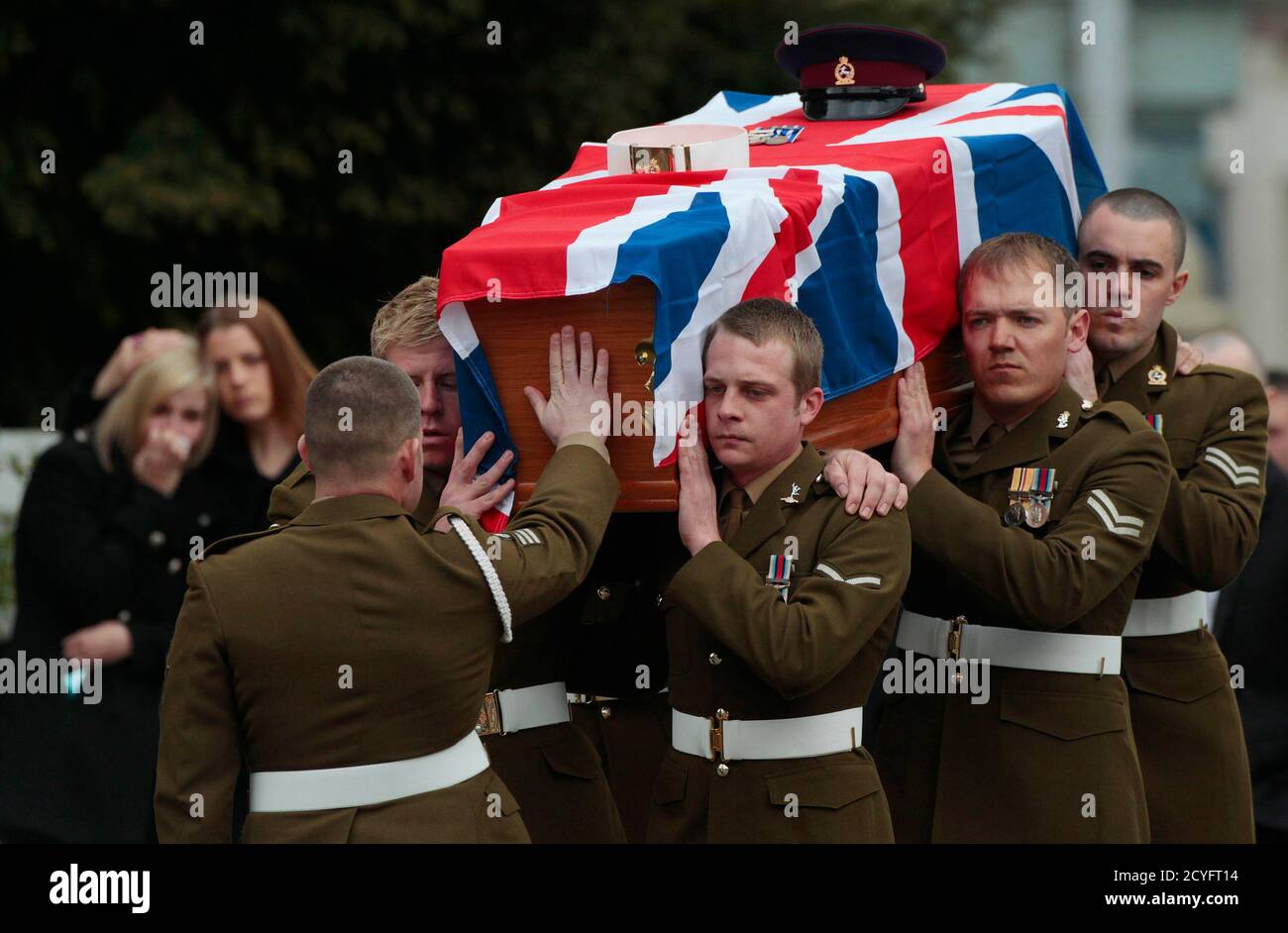 Family members watch as the coffin of Lance Corporal Tasker is carried to  his funeral service at Tayport Parish Church, in Tayport, Scotland March  22, 2011. Lance Corporal Tasker was killed by