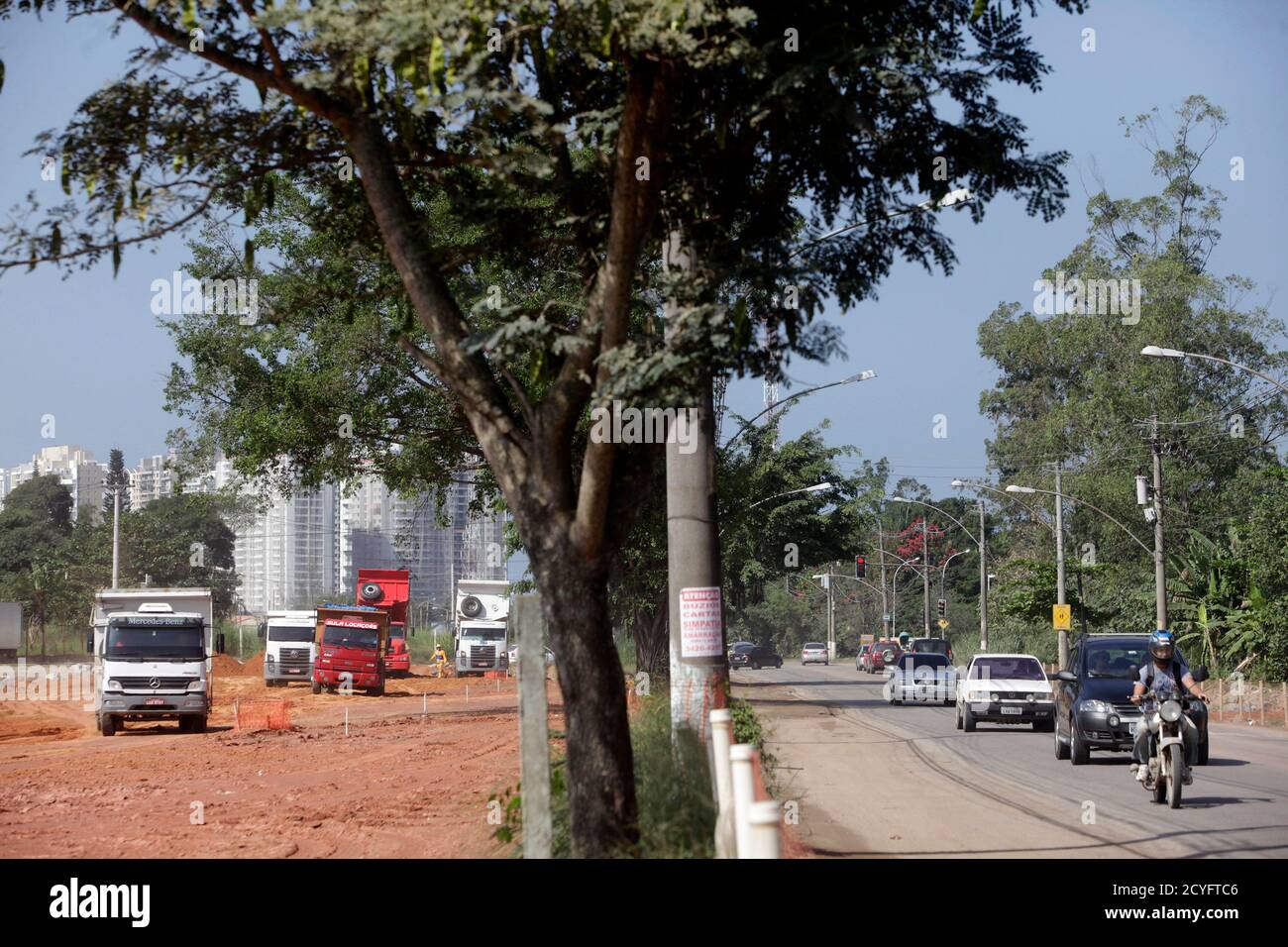 Trucks (L) are seen at a construction site where houses were demolished to  make way for special bus routes in Recreio do Bandeirantes neighborhood in  Rio de Janeiro May 5, 2011. The