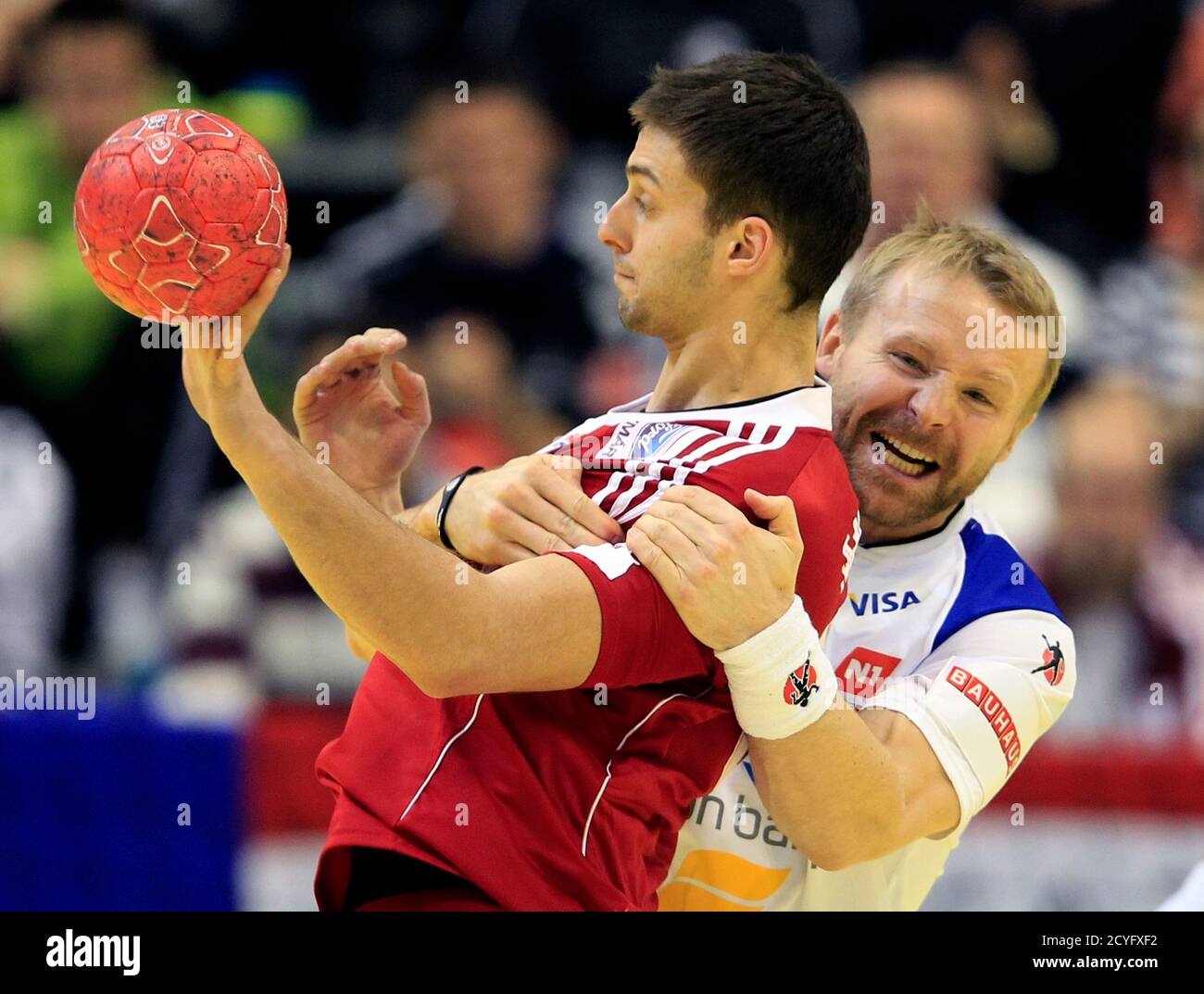 Ingimundur Ingimundarson struggles with Hungary's Gabor Ancsin during their Men's European Handball Championship main match in Novi Sad January 22, REUTERS/Laszlo Balogh (SERBIA - Tags: SPORT HANDBALL Stock