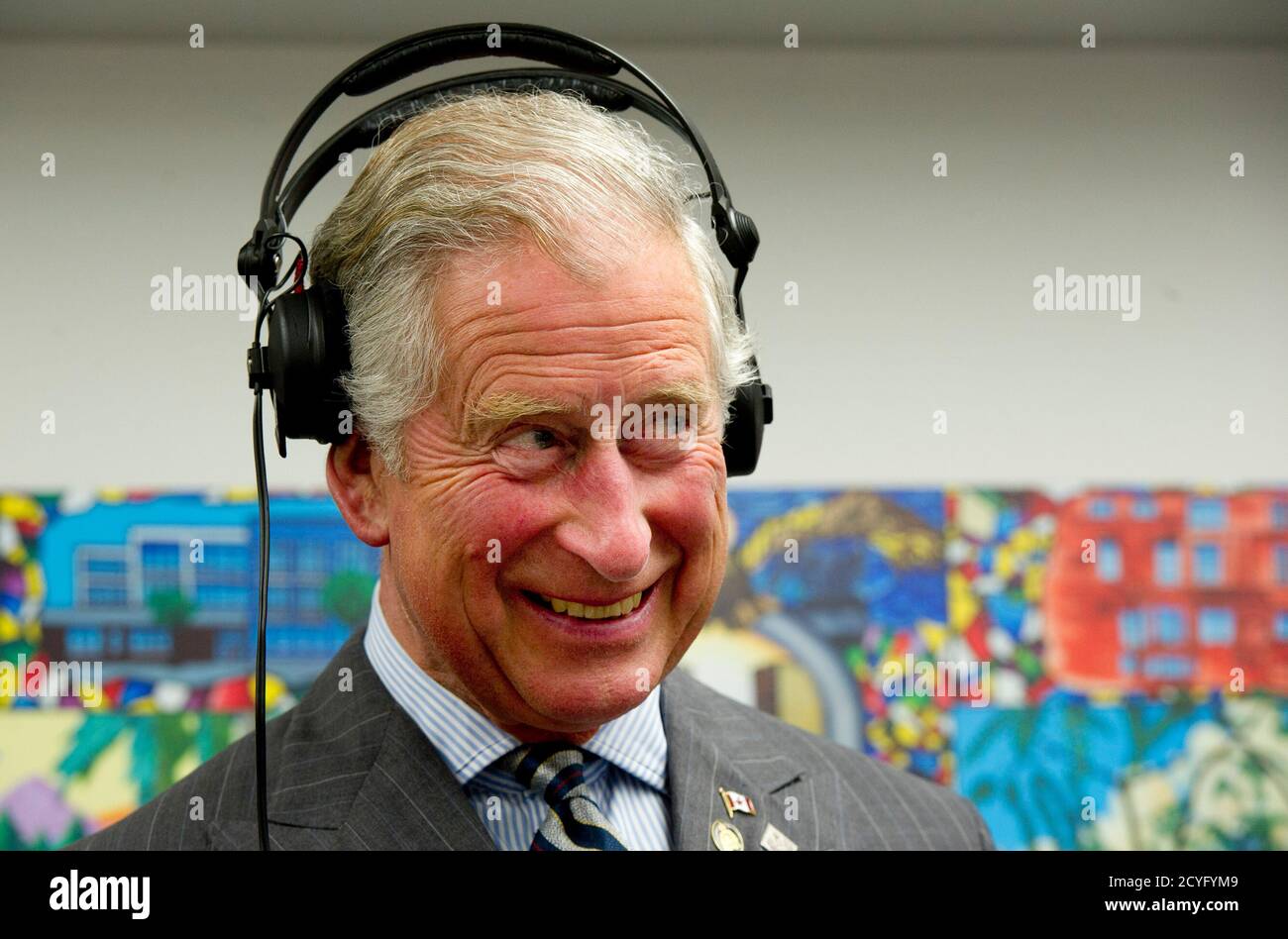 Prince Charles wears headphones as learns how to scratch and fade with a  turntable while he tours an employment skills workshop in Toronto May 22,  2012. The royal couple is on a