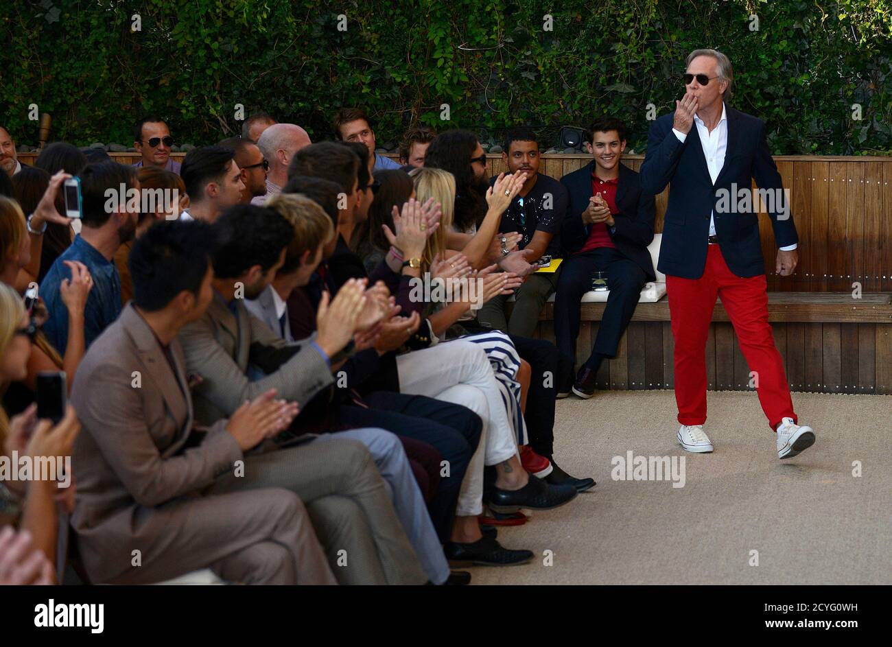 Fashion designer Tommy Hilfiger blows a kiss to the audience at the end of  the showing of his Spring/Summer 2013 collection during New York Fashion  Week September 7, 2012. REUTERS/Keith Bedford (UNITED