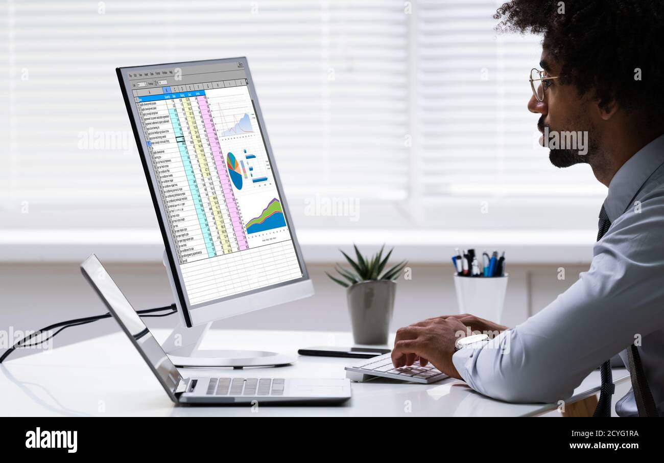 Analyst Employee Working With Spreadsheet On Computer Stock Photo