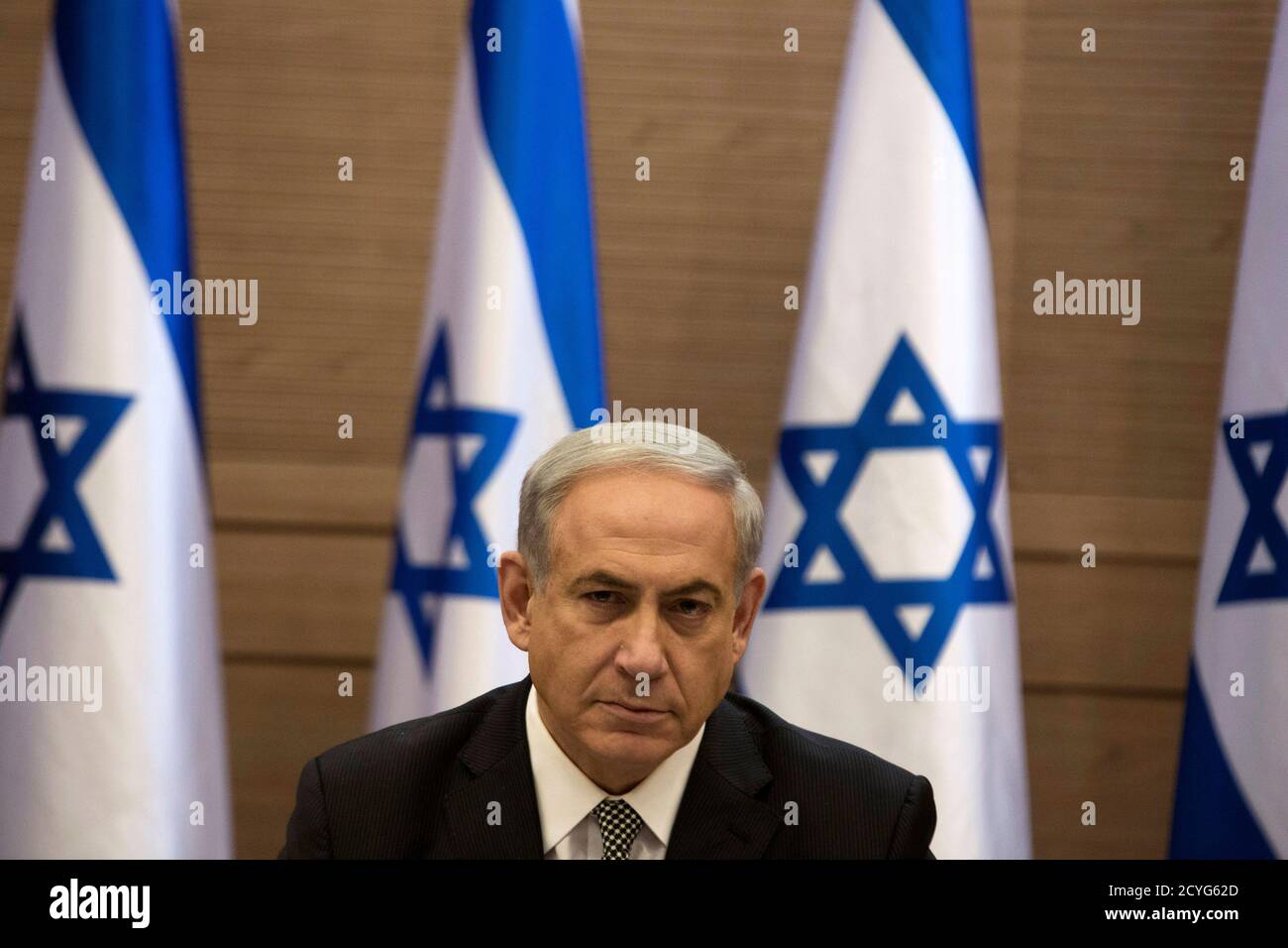 Israel's Prime Minister Benjamin Netanyahu heads a cabinet meeting in Jerusalem July 24, 2014. Israel won a partial reprieve from the economic pain of its Gaza war on Thursday with the lifting of a U.S. ban on commercial flights to Tel Aviv, as fighting pushed the Palestinian death toll over 700. A truce remained elusive despite intensive mediation bids. Israel says it needs more time to eradicate cross-border tunnels used by Hamas for attacks, while the Palestinian Islamists demand the blockade on the Gaza Strip be lifted. REUTERS/Siegfried Modola     (JERUSALEM - Tags: POLITICS CONFLICT) Stock Photo
