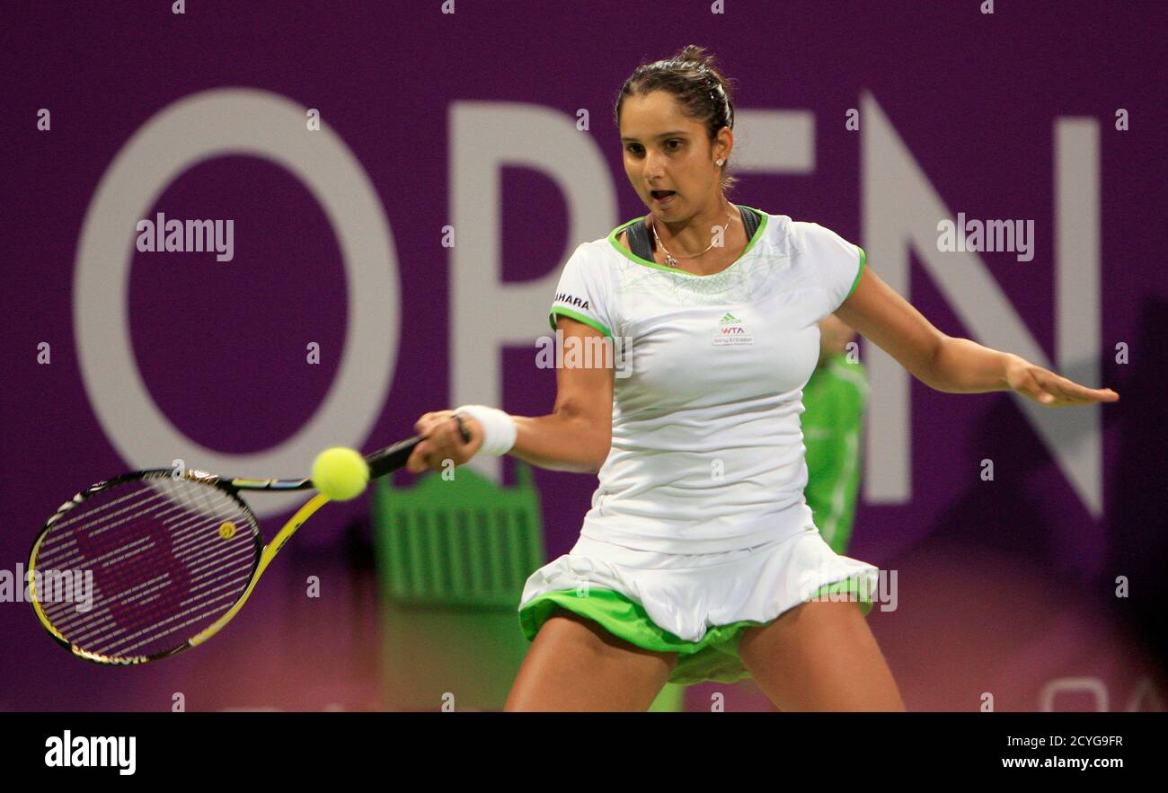 Sania Mirza of India returns the ball to Jelena Jankovic of Serbia during  their match at the WTA Doha Tennis Championships February 23, 2011.  REUTERS/Mohammed Dabbous (QATAR - Tags: SPORT TENNIS Stock