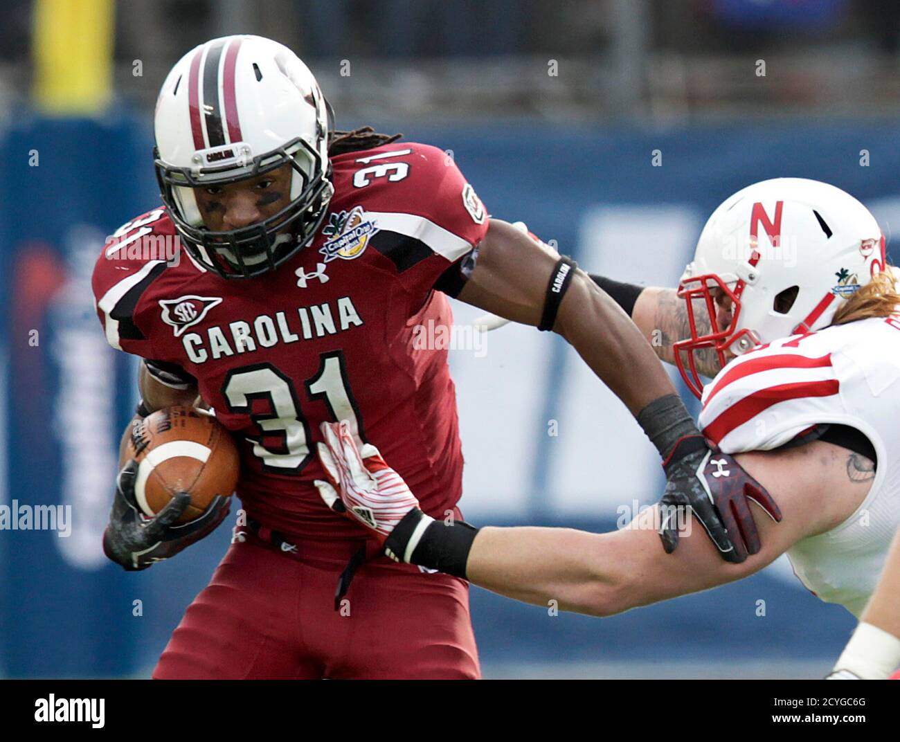 south-carolina-gamecocks-running-back-kenny-miles-31-breaks-free-from-nebraska-cornhuskers-linebacker-will-compton-51-during-the-capital-one-bowl-ncaa-college-football-game-in-orlando-florida-january-2-2012-reuterspierre-ducharmeunited-states-tags-sport-football-2CYGC6G.jpg