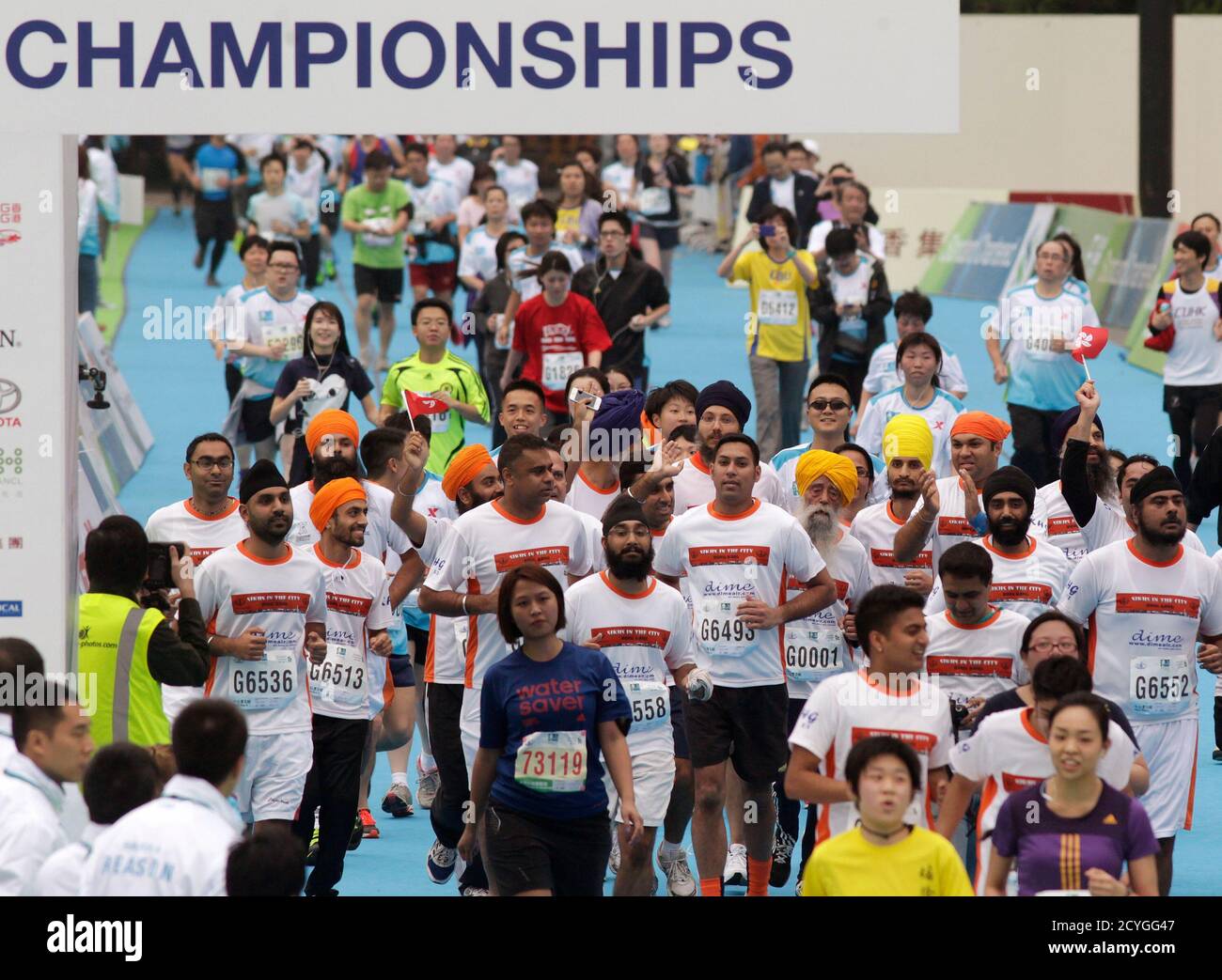 British Indian marathon runner Fauja Singh (G0001), 101, and Indian runners cross