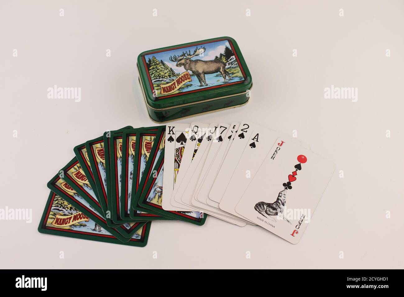 Mangy Moose playing cards in a fan with metal tin advertising an American steakhouse in Jackson Hole, Wyoming, USA. Isolated on white background Stock Photo
