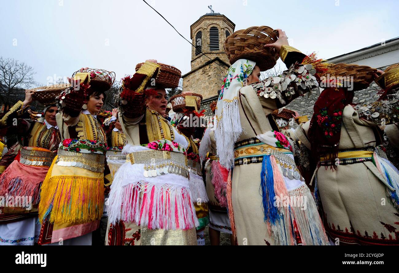 Villagers dressed in traditional folk costumes take part in an Epiphany day  celebration in Bitushe village, about 150km west from the capital Skopje,  January 19, 2014. Bitushe practises a different Epiphany tradition.
