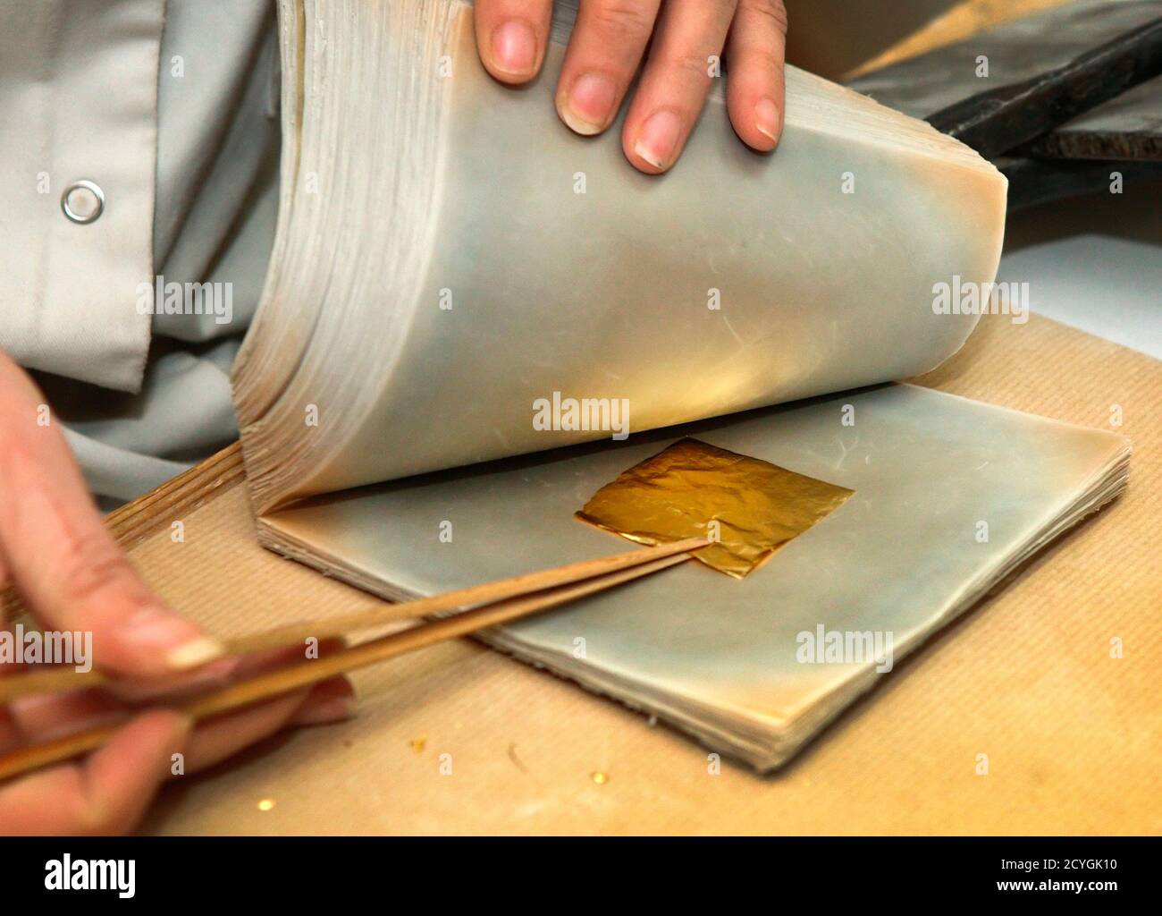 Gold leaf is separated at Erich Dungl's gold leaf workshop in Schwechat  March 4, 2014. Each handmade sheet of gold leaf is produced by squeezing  and hammering gold to a thickness of