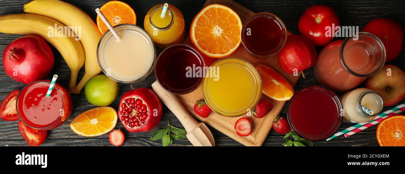 Glasses and jars with different juices on wooden background Stock Photo