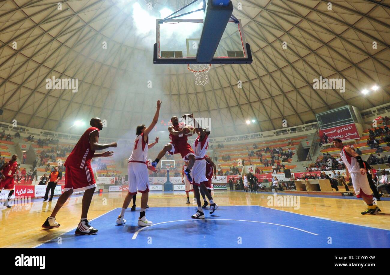 Ahli Benghazi's Tomes Tylen (3rd L) fights for the ball during a basketball game against the Libyan National team during their Ahli International basketball championship in Benghazi April 22, 2012. REUTERS/Esam Al-Fetori    (LIBYA - Tags: SPORT BASKETBALL) Stock Photo