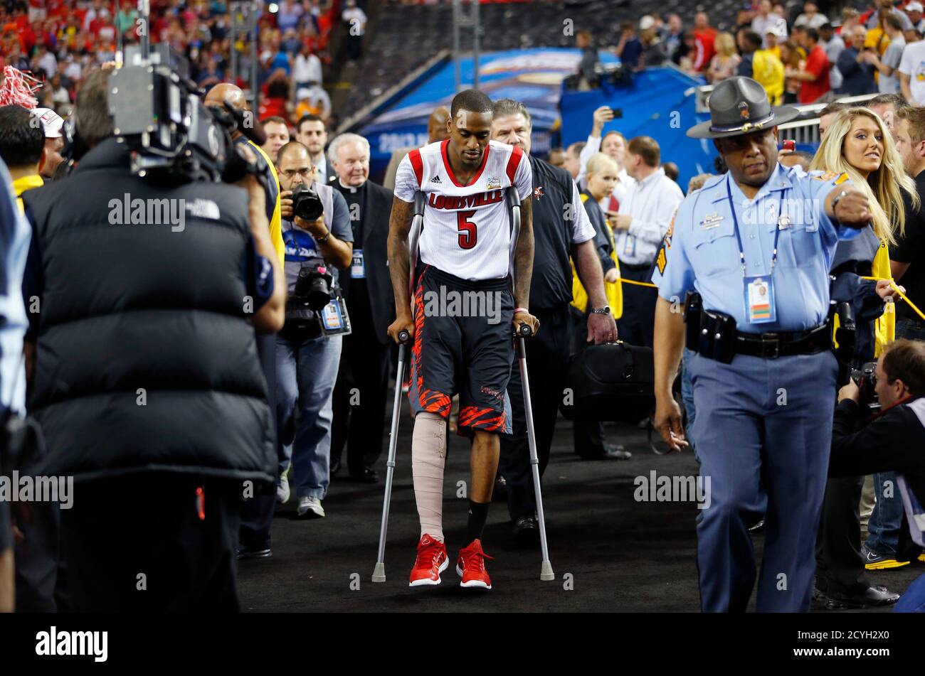 Injured Louisville Cardinals guard Kevin Ware comes to the court ahead of  his team's NCAA men's Final Four basketball game against the Wichita St.  Shockers in Atlanta, Georgia April 6, 2013. REUTERS/Chris