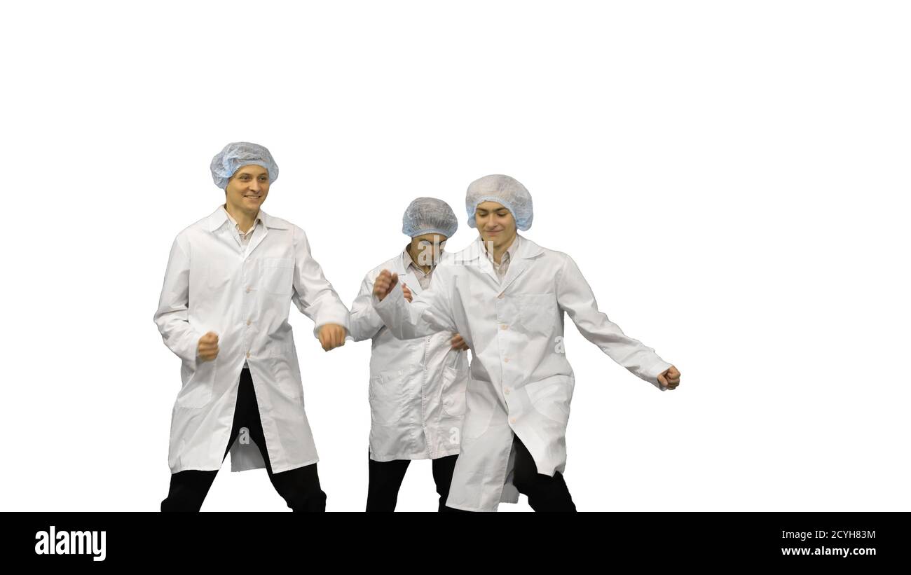 Three male doctors in white robes and protective caps running in Stock Photo