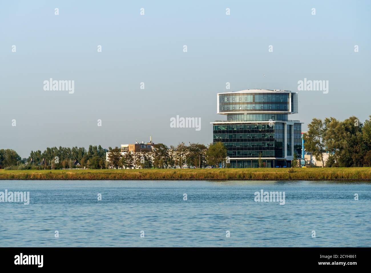 Dordrecht, Netherlands - 14 September 2020: View across the river Maas of the new Fokker head office between Dordrecht and Papendrecht. The river Maas is an important inland shipping route to Rotterdam. Stock Photo