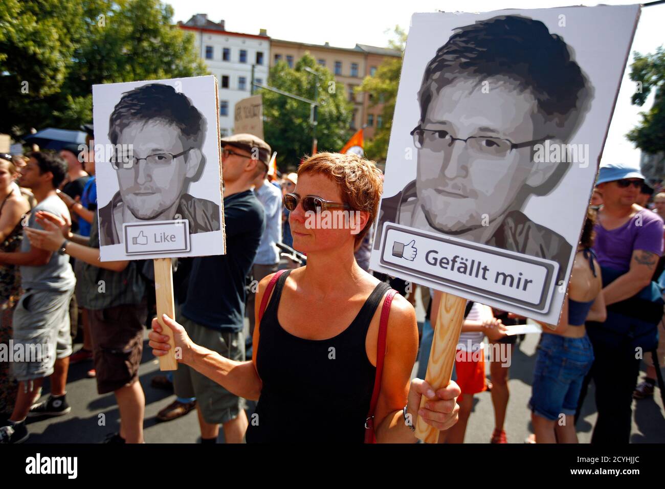 A protester carry two portraits of Edward Snowden during a demonstration against secret monitoring programmes PRISM, TEMPORA, INDECT and showing solidarity with whistleblowers Edward Snowden, Bradley Manning and others in Berlin July 27, 2013. REUTERS/Pawel Kopczynski (GERMANY  - Tags: CIVIL UNREST) Stock Photo