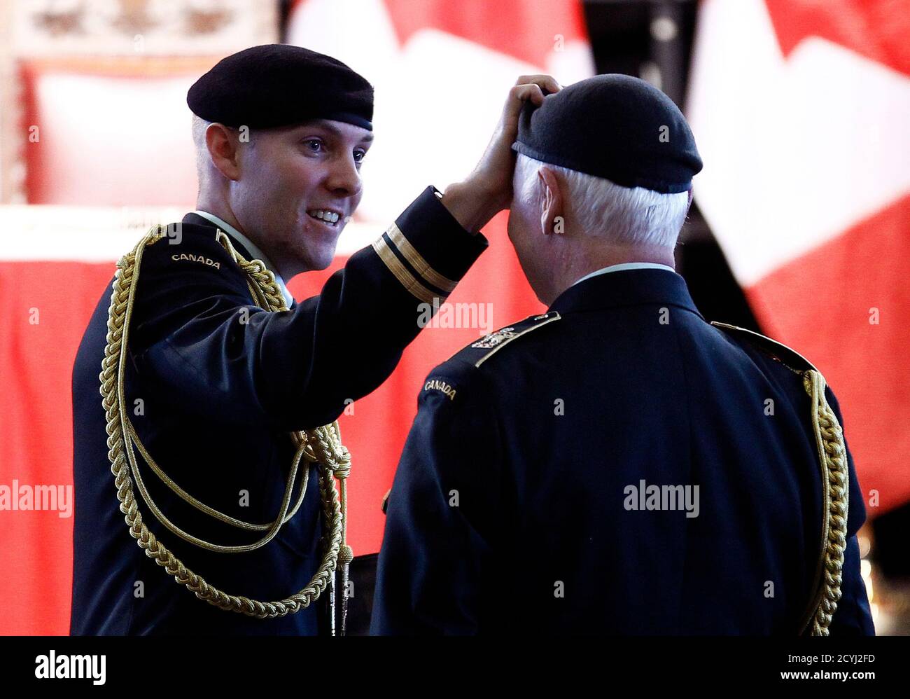 An aide-de-camp adjusts the Governor General David Johnston's headdress  during a Canadian Forces change of command ceremony at the Canadian War  Museum in Ottawa October 29, 2012. REUTERS/Chris Wattie (CANADA - Tags: