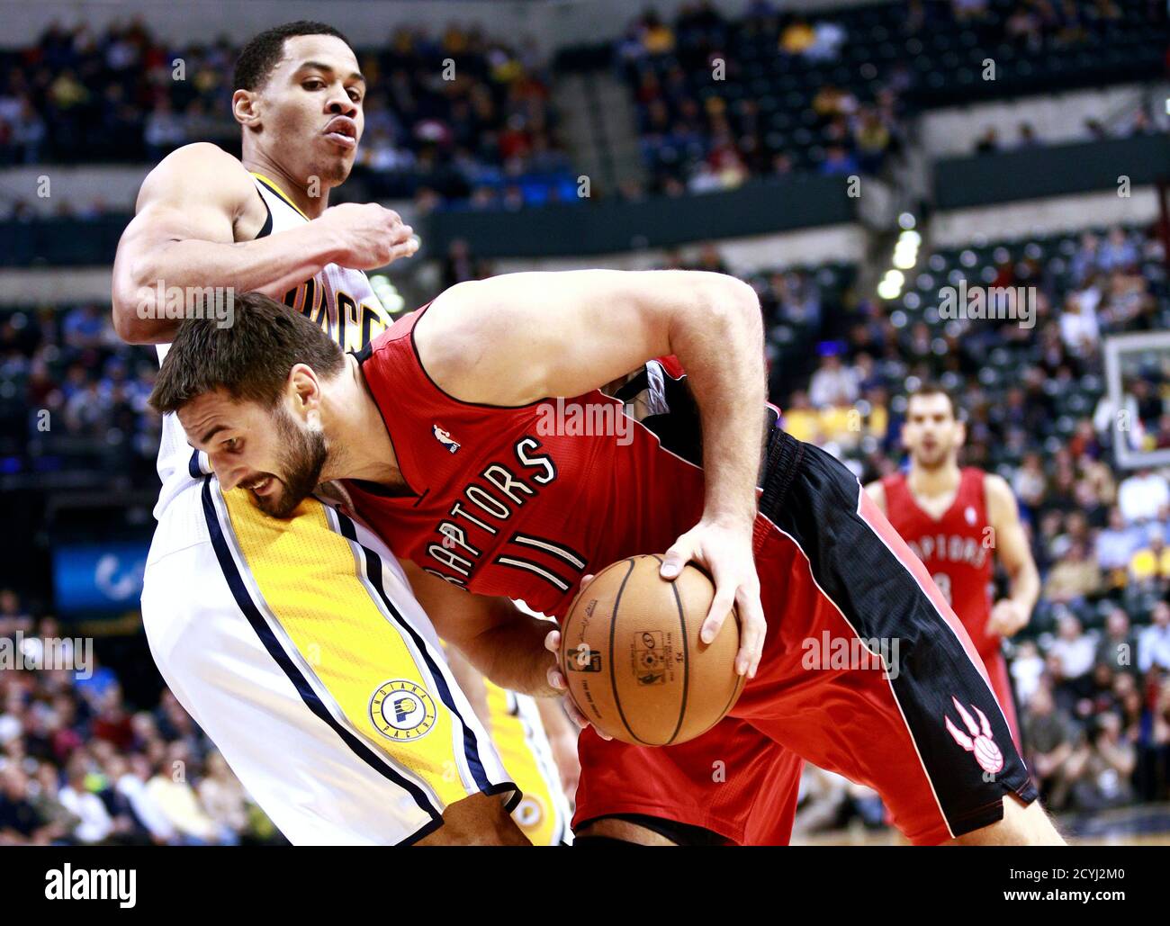 Toronto Raptors forward Linas Kleiza (11) of Lithuania collides with  Indiana Pacers guard Gerald Green during the second quarter of an NBA  basketball game in Indianapolis November 13, 2012. REUTERS/Brent Smith  (UNITED