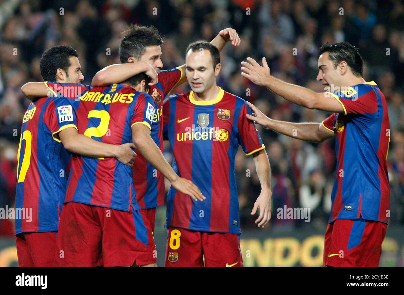 Barcelona S Players Pedro L David Villa 3rd L Andres Iniesta 2nd R And Xavi Hernandez R Celebrate Dani Alves 2nd L Goal Against Sevilla During Their Spanish First Division Soccer Match At