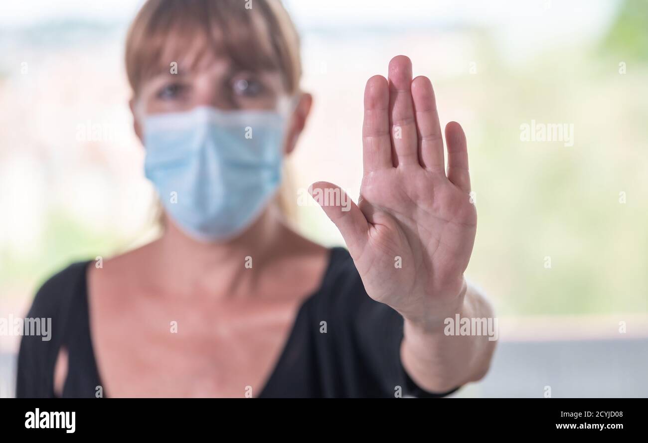 Short Stop Mask Woman with medical face mask having a stop gesture; virus protection ...
