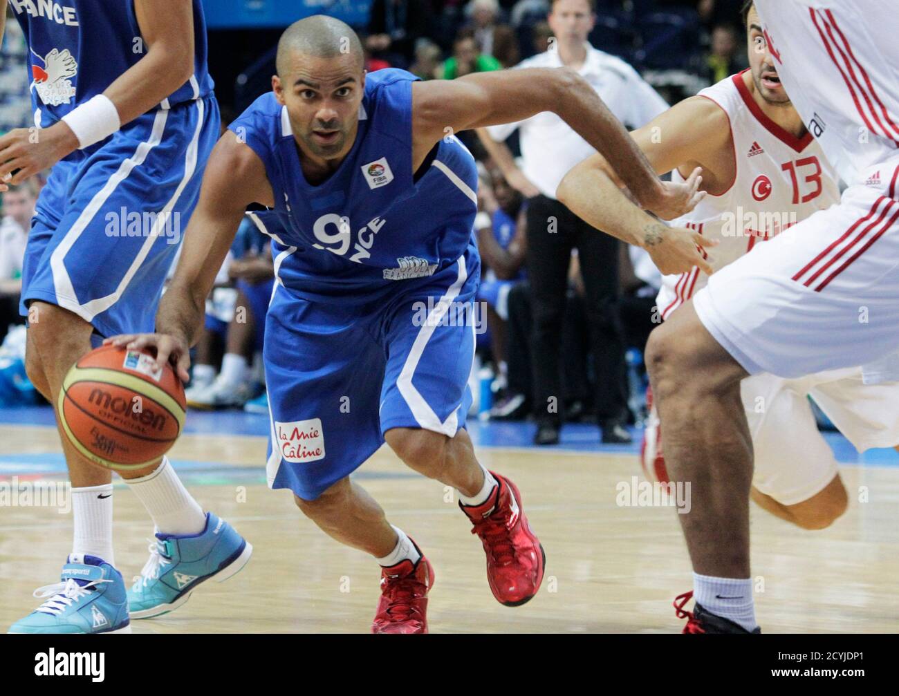Tony Parker of France (L) drives past Ender Arslan of Turkey (13) during their FIBA EuroBasket 2011 Group E basketball game in Vilnius September 7, 2011.    REUTERS/Ints Kalnins (LITHUANIA - Tags: SPORT BASKETBALL) Stock Photo