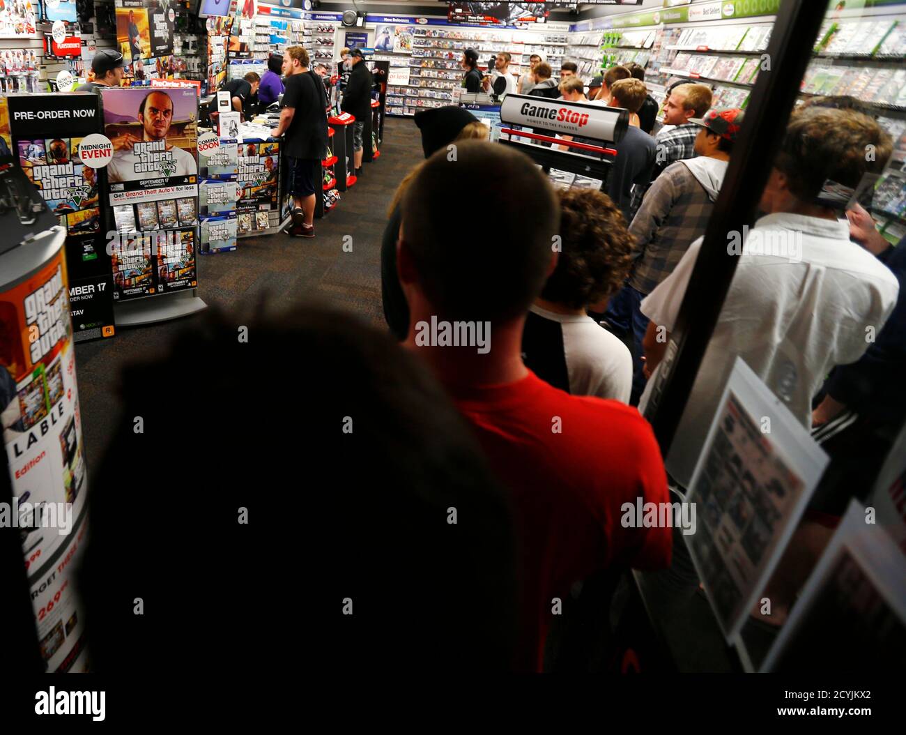 Gaming enthusiasts file in after midnight at a local Game Stop gaming store  to purchase the latest release of "Grand Theft Auto Five" in Encinitas,  California September 17, 2013. The launch comes