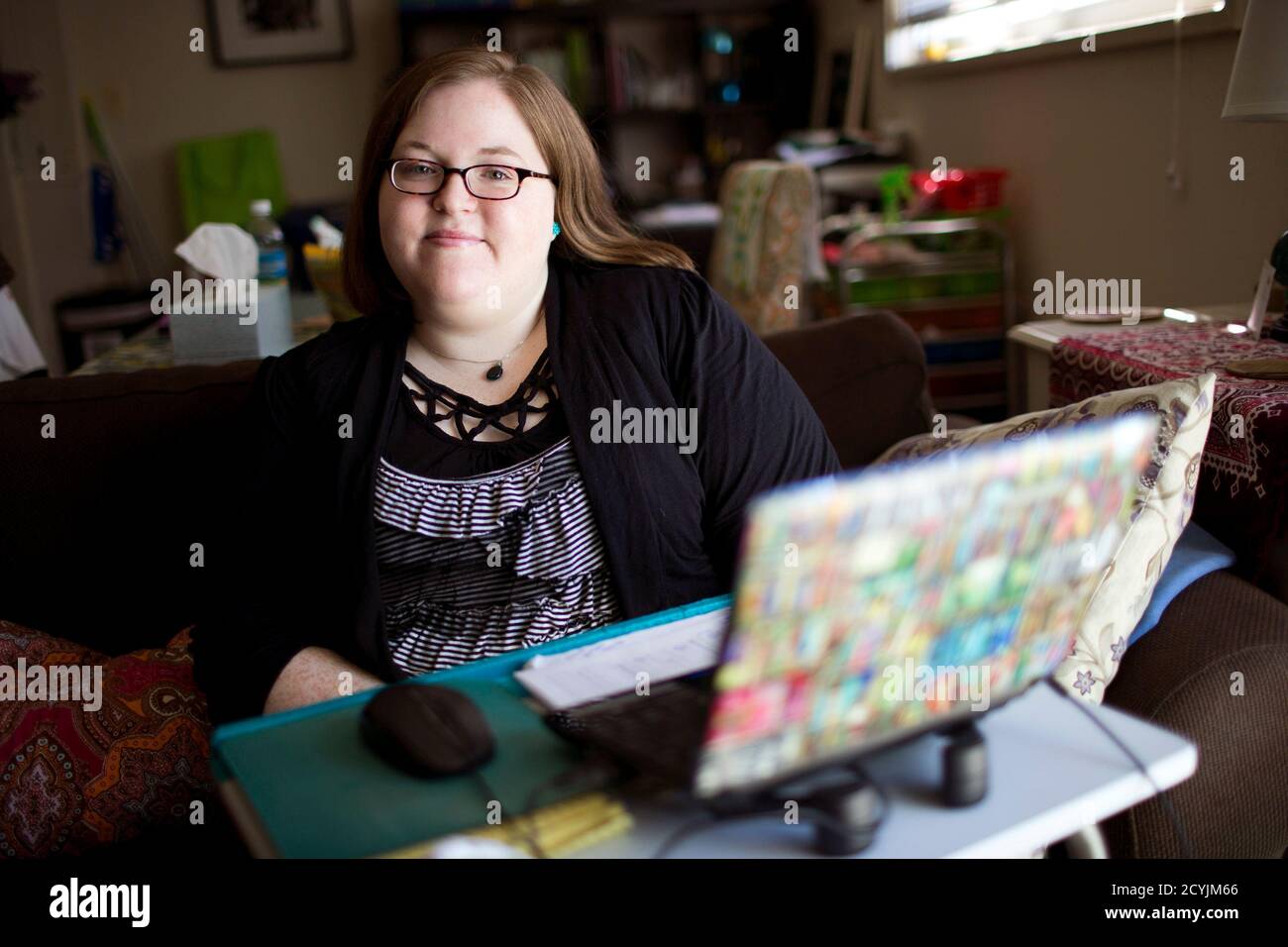 Cassandra Bales, who is looking to sign up for Obamacare, poses for a portrait in her home in Suitland, Maryland, on October 15, 2013. Uninsured Americans are showing more interest in the coverage offered under President Barack Obama's healthcare law despite technical problems that have hindered enrollment through a government website, according to a Reuters/Ipsos poll. Picture taken October 15, 2013. REUTERS/Joshua Roberts    (UNITED STATES - Tags: POLITICS HEALTH PORTRAIT) Stock Photo