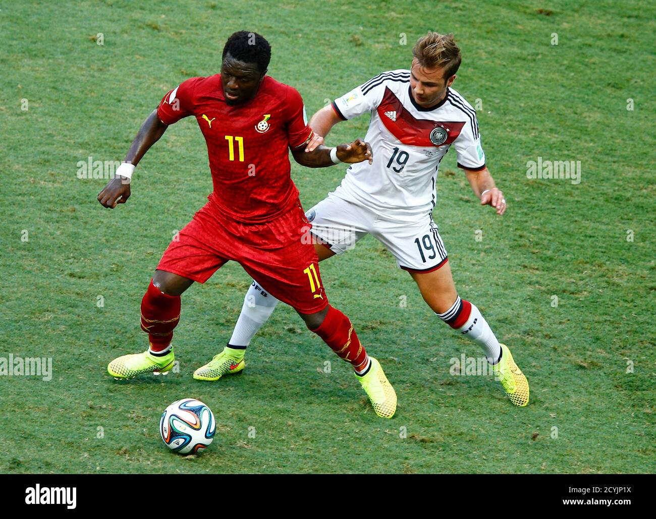 Ghana's Sulley Muntari is challenged for the ball by Germany's Mario Goetze (R) during their 2014 World Cup Group G soccer match at the Castelao arena in Fortaleza June 21, 2014. REUTERS/Mike Blake (BRAZIL  - Tags: SOCCER SPORT WORLD CUP) Stock Photo