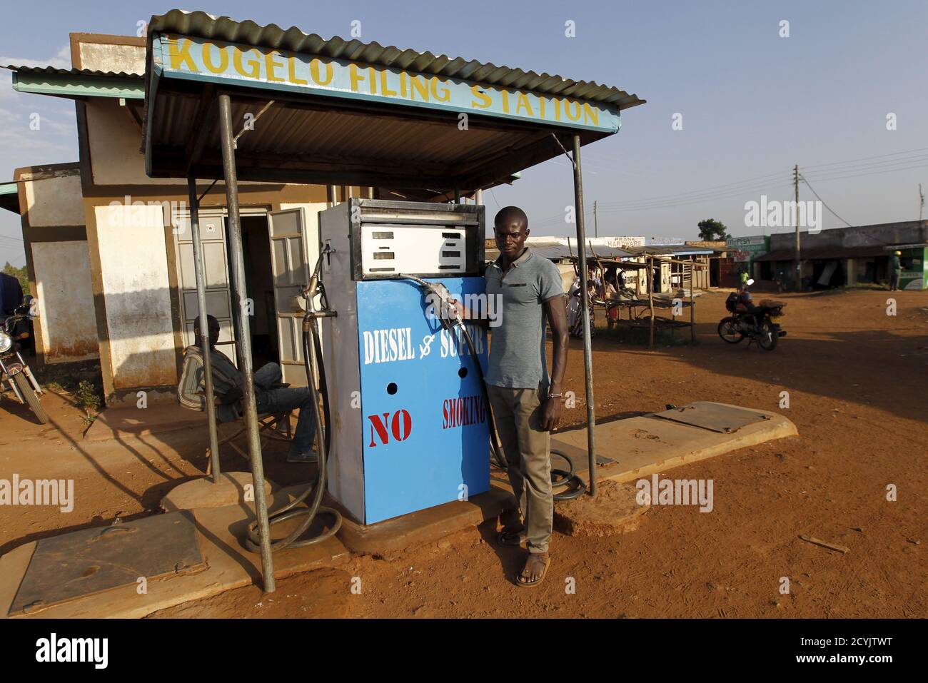 Kevin Oloo, a fuel pump attendant poses for a photograph next to his pump-machine at the trading centre in the U.S. President Barack Obama's ancestral village of Nyang'oma Kogelo, west of Kenya's capital Nairobi, July 15, 2015. Oloo, 25, said we expect investors to bring better facilities like modern fuel stations as well as food processing factories. 'With the U.S. Presidency, Nyang'oma Kogelo has seen better road infrastructure and improved security' he said. President Obama visits Kenya and Ethiopia in July, his third major trip to Sub-Saharan Africa after travelling to Ghana in 2009 and to Stock Photo