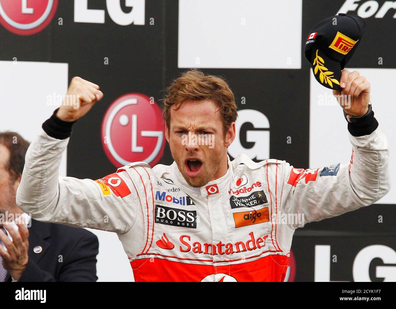 McLaren Formula One driver Jenson Button of Britain celebrates winning the Canadian F1 Grand Prix on the podium at the Circuit Gilles Villeneuve in Montreal June 12, 2011.   REUTERS/Chris Wattie (CANADA - Tags: SPORT MOTOR RACING IMAGES OF THE DAY) Stock Photo