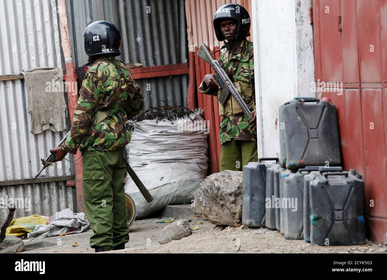 Policemen patrol deserted streets of the Kenyan coastal city of Mombasa, August 29, 2012. Kenya's prime minister said on Wednesday the country's enemies were behind the killing of a Muslim cleric that triggered riots he described as being conducted by an 'underground organisation' to create divisions between Christians and Muslims. REUTERS/Thomas Mukoya (KENYA - Tags: SOCIETY RELIGION POLITICS CIVIL UNREST) Stock Photo