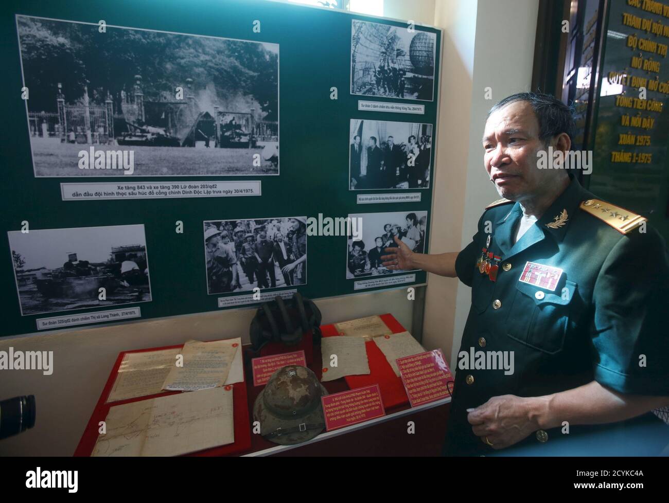 Veteran Phung Ba Dam points to a photo showing him and his team with former  South Vietnamese President Duong Van Minh and Prime Minister Vu Van Mau, as  they made a radio