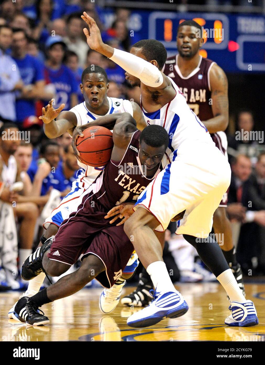 Texas A&M Aggies guard Andrew Darko drives into Kansas Jayhawks forward
