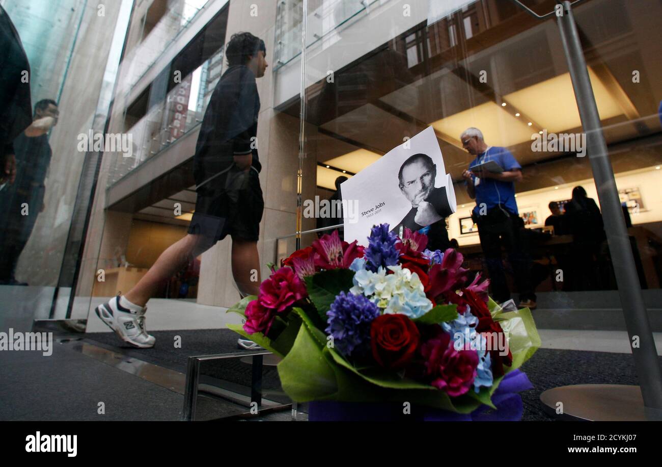 A Customer Arrives To An Apple Store After Flowers In Memory Of Apple Co Founder Steve Jobs Were Placed At The Entrance In Central Sydney October 6 2011 Apple Inc Co Founder And Former