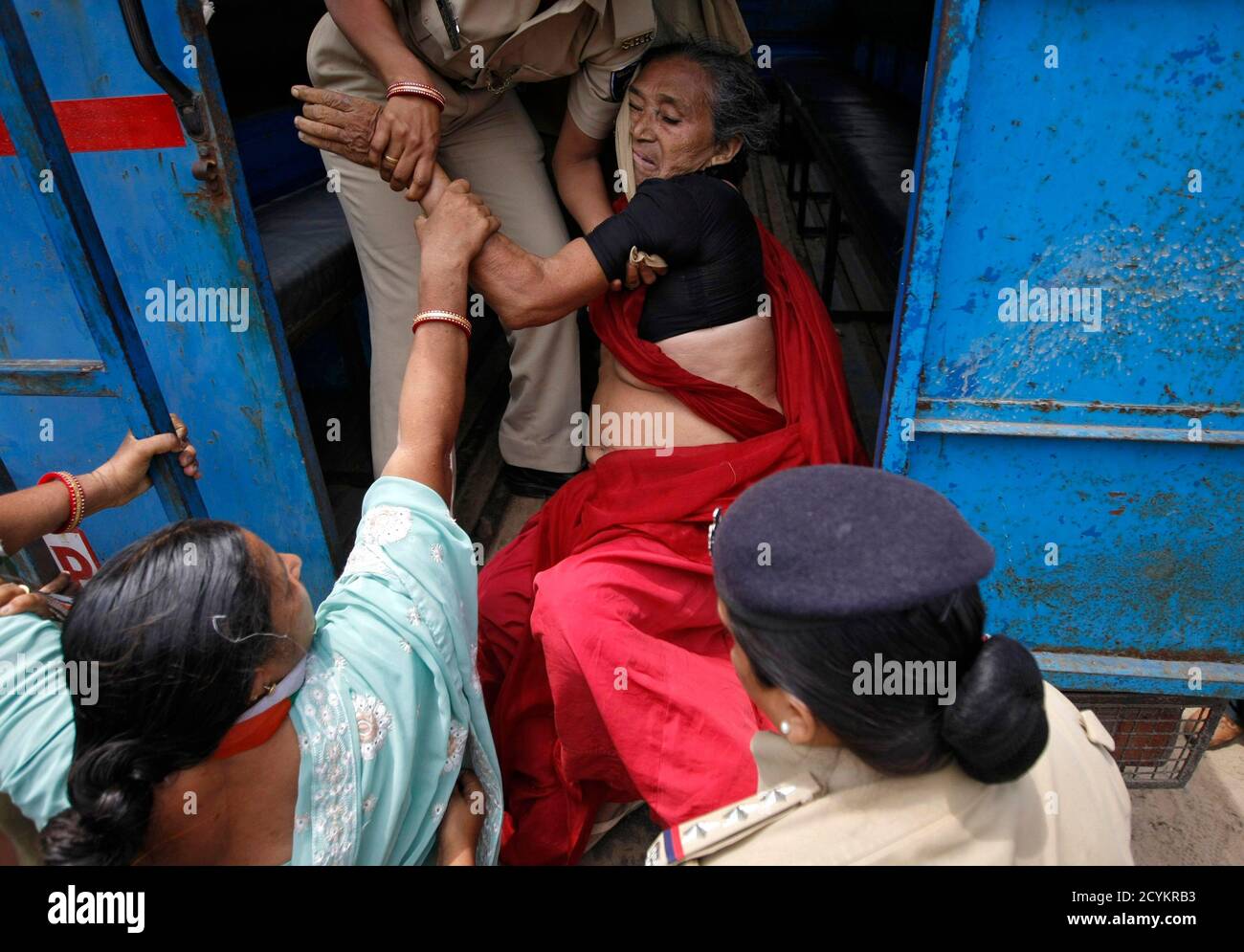 A demonstrator is detained by police during a protest at Gandhinagar in the western Indian state of Gujarat August 23, 2013. Hundreds of demonstrators on Friday attempted to reach the residence of Gujarat's chief minister Narendra Modi to demand basic amenities including water, roads, electricity for villagers, protesters said. REUTERS/Amit Dave (INDIA - Tags: CIVIL UNREST CRIME LAW) Stock Photo