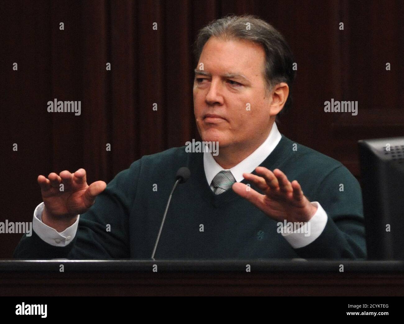 Defendant Michael Dunn gestures on the stand during testimony in his own defense during his murder trial in Duval County Courthouse in Jacksonville, Florida February 11, 2014. Dunn is accused of first degree murder in the death of unarmed teenager Jordan Davis after an altercation over loud rap music at a Florida gas station in November 2012.  REUTERS/Bob Mack/Pool   (UNITED STATES - Tags: CRIME LAW) Stock Photo