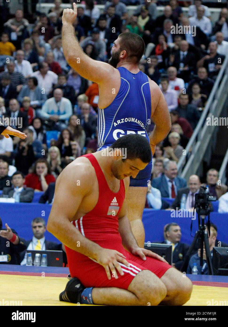 Ioannis Arzoumanidis of Greece celebrates his victory over Ali Isayev of  Azerbaijan (red) during their 120 kg men's free style bronze medal match at  the World Wrestling Championships in Moscow September 12,