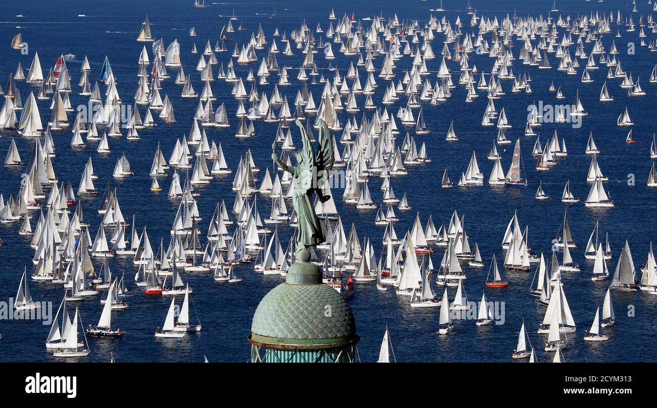 Sailing boats gather at the start of the Barcolana regatta in front of Trieste harbour October 10, 2010. The annual Barcolana regatta in the Gulf of Trieste near northern Italy is one of the largest sailing races in the world with over 2000 participants. It takes place on the second Sunday in October and began in 1969.  REUTERS/Alessandro Bianchi (ITALY - Tags: ENTERTAINMENT SPORT YACHTING IMAGES OF THE DAY) Stock Photo