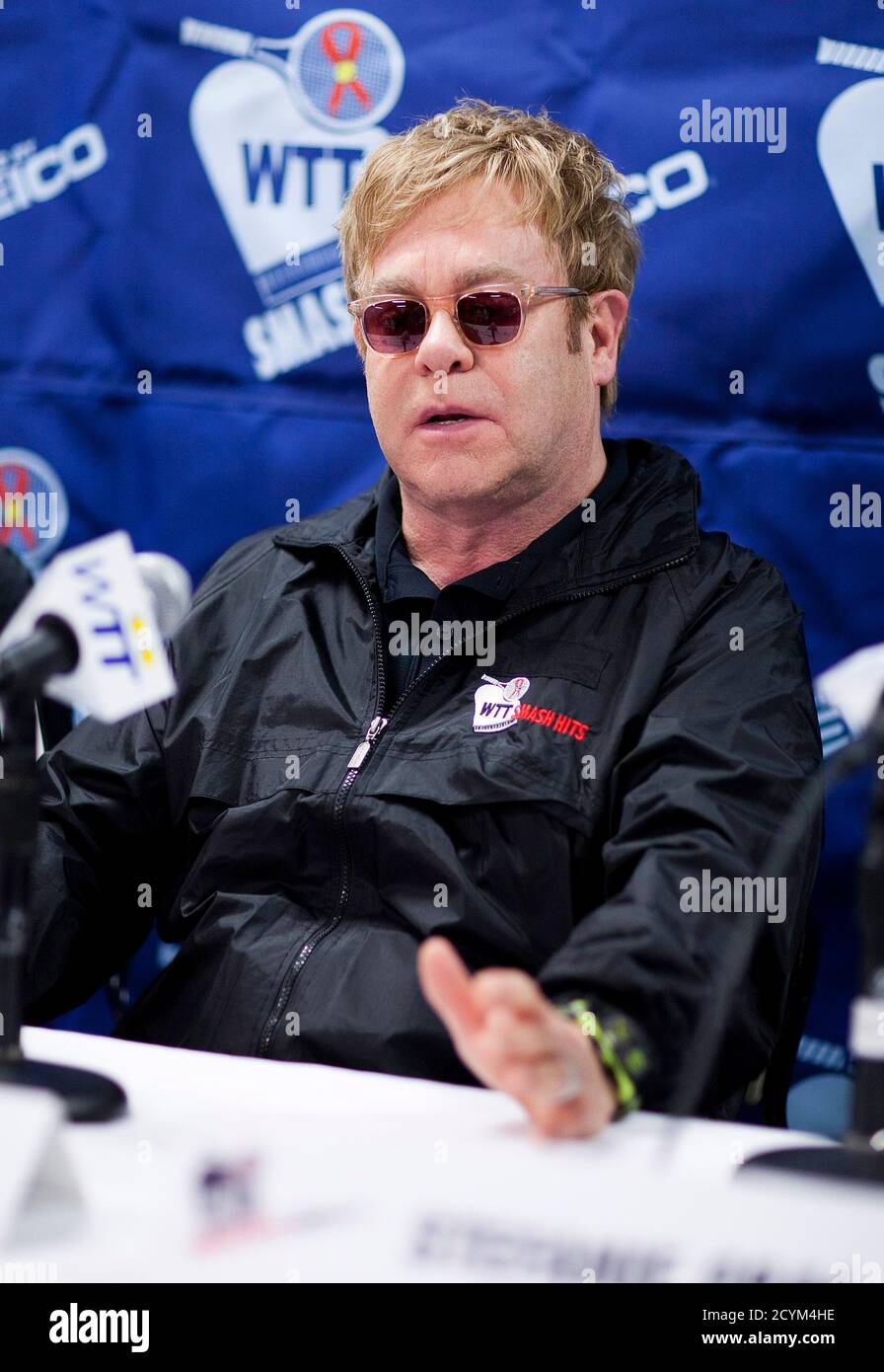 Sir Elton John speaks at a news conference for the World Team Tennis Smash Hits fundraiser in Washington November 15, 2010. The event will raise money for the Elton John AIDS Foundation and local Washington, D.C. Area AIDS charities, according to the World Team Tennis website. REUTERS/Joshua Roberts    (UNITED STATES - Tags: SPORT TENNIS ENTERTAINMENT) Stock Photo