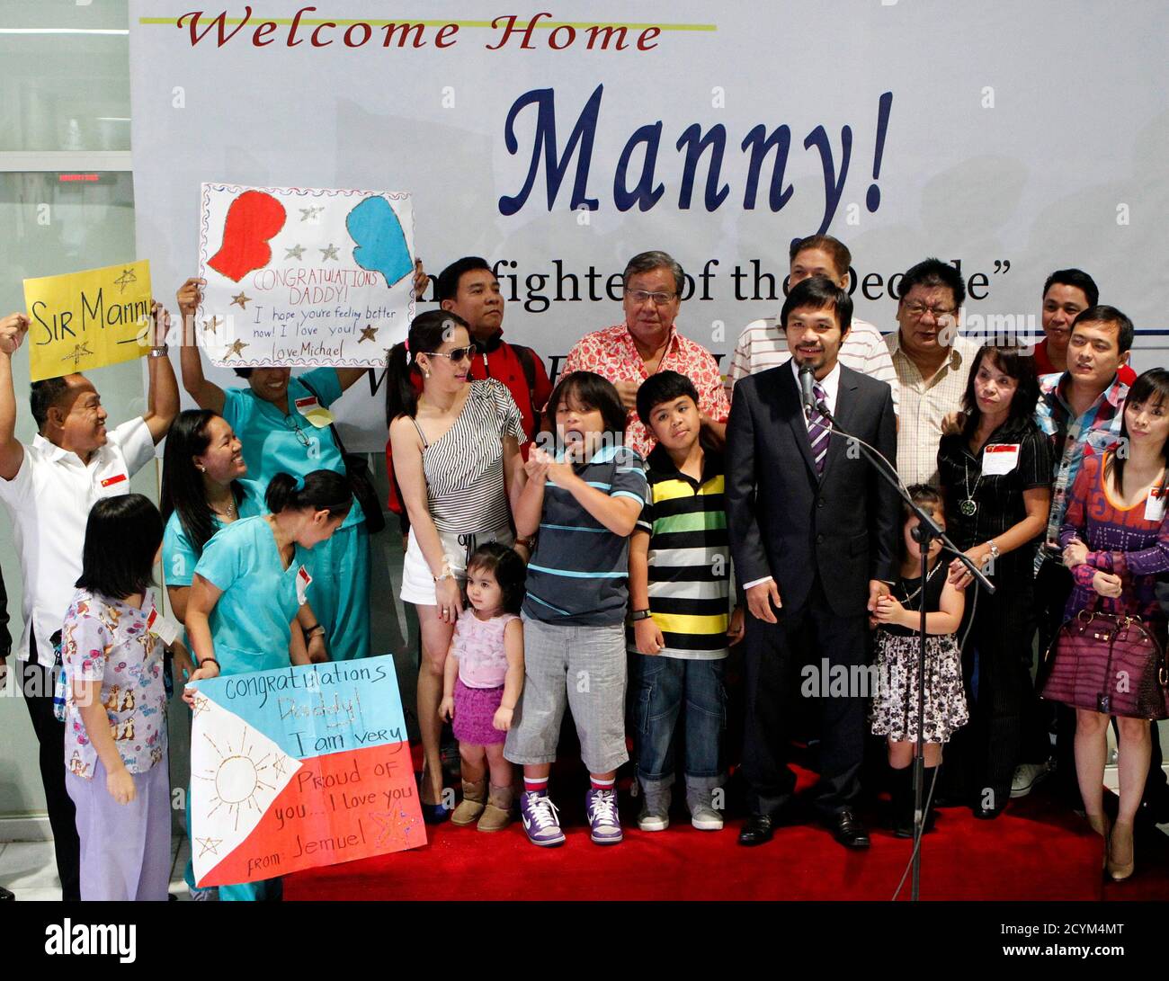 Filipino Boxing Champion Manny Pacquiao Poses With His Family And Supporters Upon Arrival At The Manila International Airport In Manila From Los Angeles November 20 2010 Pacquiao Now A Philippine Congressman Eventually