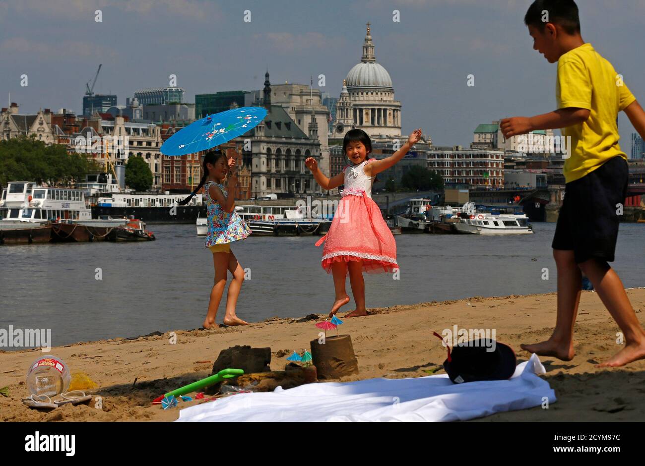 Julia Yeung (L) and Amy Liu from London enjoy the hot weather on the banks of the River Thames ahead of the London 2012 Olympic Games July 25, 2012.     REUTERS/Eddie Keogh (BRITAIN - Tags: ENVIRONMENT SPORT OLYMPICS CITYSPACE) Stock Photo