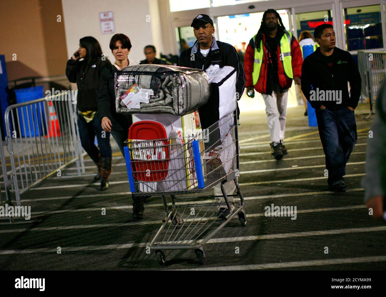 A man pushes a loaded shopping cart at a Walmart store, on Thanksgiving day in  North Bergan, New Jersey November 22, 2012. Traditionally, retailers  enticed shoppers with "doorbuster" deals early Friday morning.