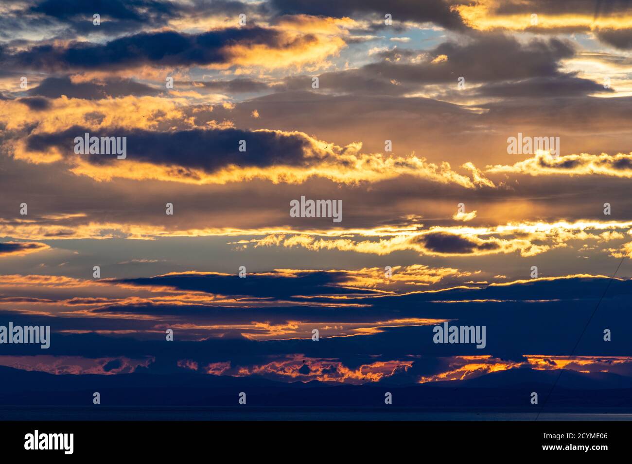 a background of colourful clouds during a sunset on the Mediterranean coast Stock Photo