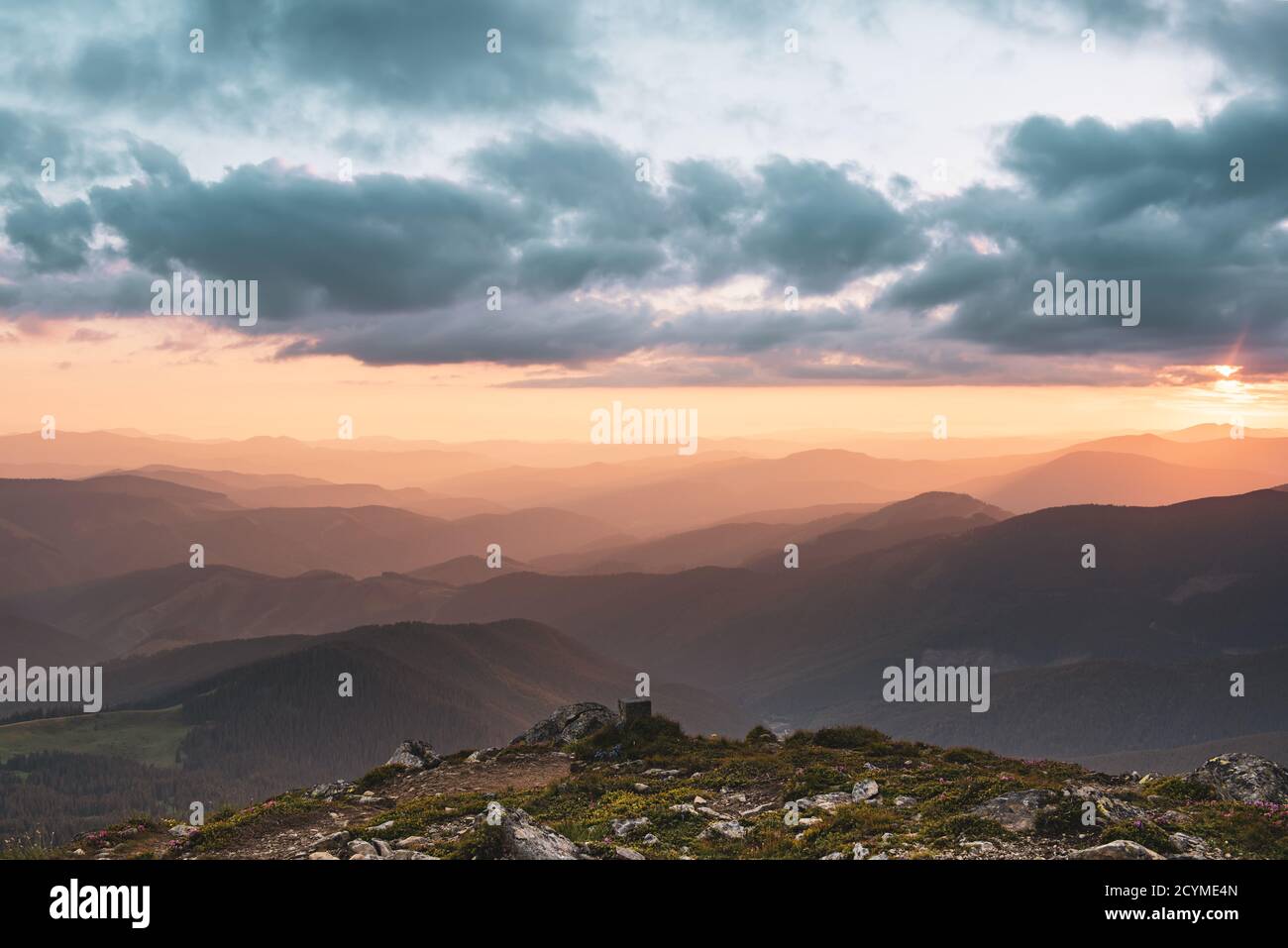 Amazing mountain landscape with colorful vivid sunset on the cloudy sky ...